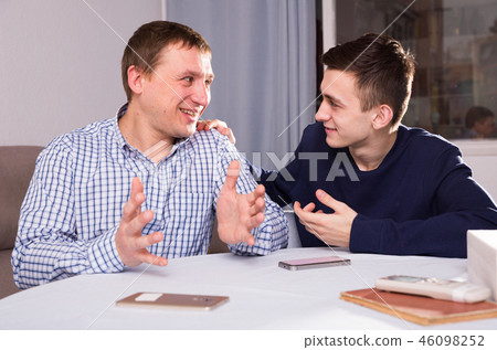 Man with his adult son are talking about life together Man with his adult son are talking about life together 46098252