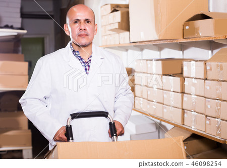 Worker performing loading works in storage Worker performing loading works in storage 46098254