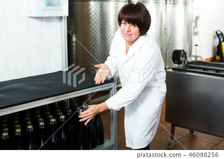 Female worker sorting wine bottles Female worker sorting wine bottles 46098256