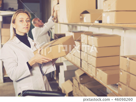 Worker standing with boxes in production workshop Worker standing with boxes in production workshop 46098260