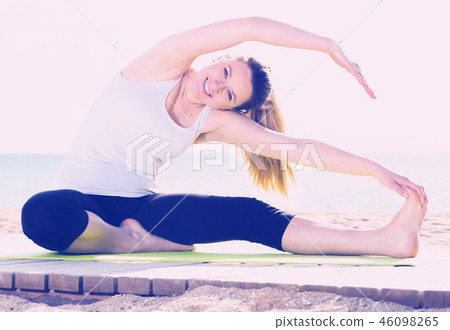 Woman doing yoga sitting Woman doing yoga sitting 46098265