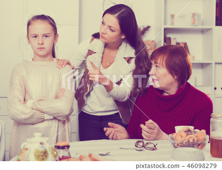 Offended little while mom and granny scolding her 46098279