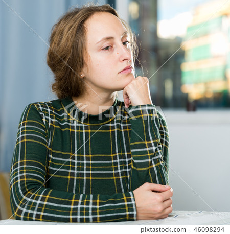 Portrait of sorrowful woman sitting at home 46098294