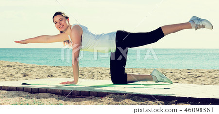 Woman doing yoga sitting Woman doing yoga sitting 46098361