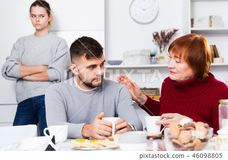 Woman calming upset guy during quarrel with girlfriend 46098805