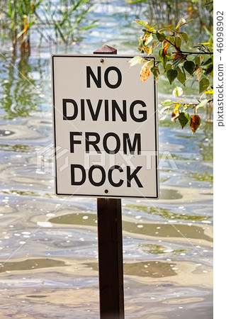 Closeup of a no diving from dock sign Closeup of a no diving from dock sign 46098902