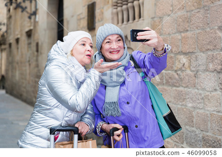 Senior ladies making selfie outdoors Senior ladies making selfie outdoors 46099058