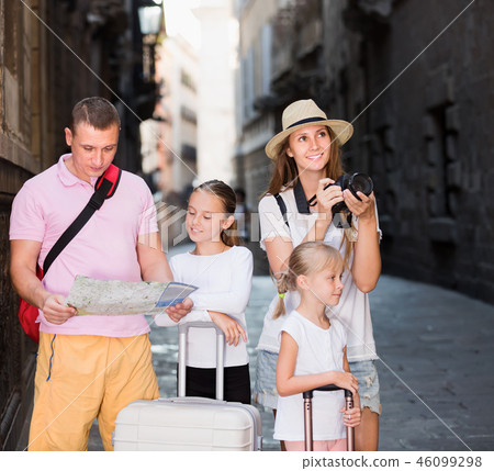 Young family with children walking with camera and map Young family with children walking with camera and map 46099298