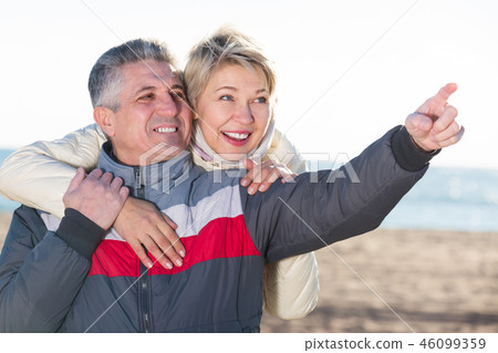 Adult husband points to something interesting 46099359