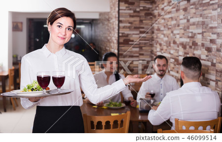 Smiling woman waitress carrying order for guest 46099514
