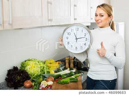 Housewife with clocks at kitchen 46099683