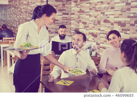 Waitress taking table order at tavern 46099685
