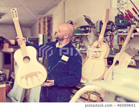 Making guitars on a small factory 46099691