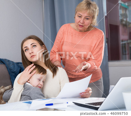 Adult woman is quarreling with her mother for documents of household 46099750