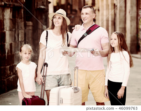 Family of tourists with map 46099763