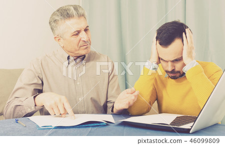 Adult father and son discuss contract Adult father and son discuss contract 46099809