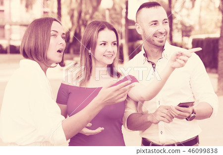 Stranger man is asking about way from young females who are walking Stranger man is asking about way from young females who are walking 46099838