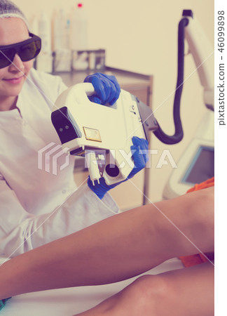 Female visitor having leg hair removed Female visitor having leg hair removed 46099898