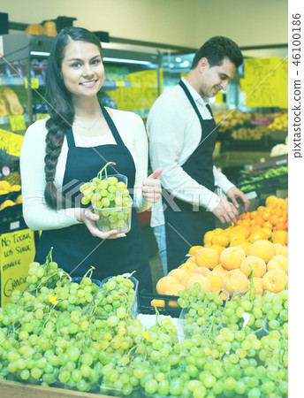 Young woman and man selling fresh fruit Young woman and man selling fresh fruit 46100186