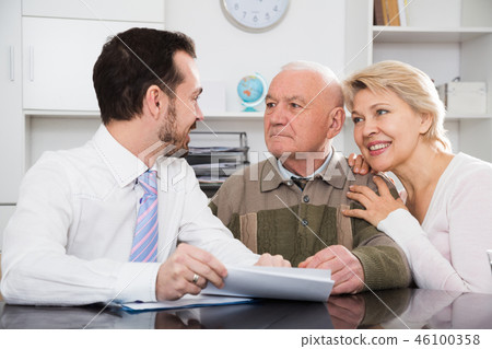 Woman and eldery man with bank employee 46100358