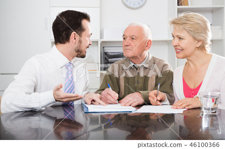 Woman and eldery man with bank employee Woman and eldery man with bank employee 46100366