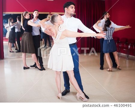 Ordinary dancing couples enjoying foxtrot Ordinary dancing couples enjoying foxtrot 46100491