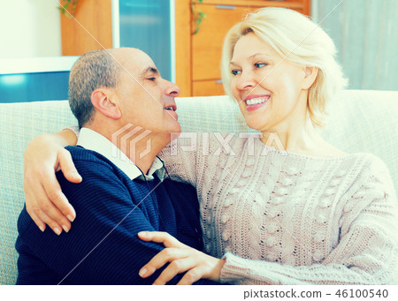 Couple pensioners together on sofa at home Couple pensioners together on sofa at home 46100540