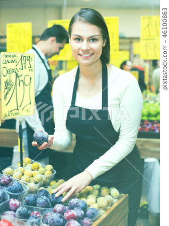 Positive smiling woman selling fresh fruit 46100863