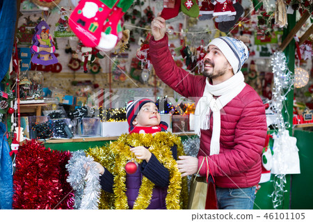 Positive man and his happy daughter are choosing gift Positive man and his happy daughter are choosing gift 46101105
