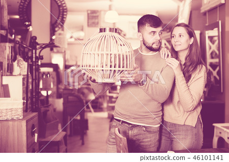 Couple looking for stylish hanging lamp Couple looking for stylish hanging lamp 46101141