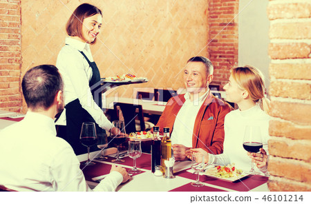 Waitress placing order in front of guests Waitress placing order in front of guests 46101214