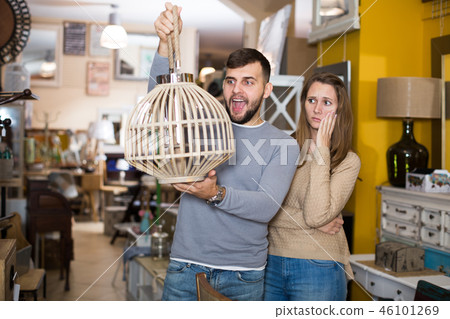 Raptured guy and surprised girl wth hanging lamp Raptured guy and surprised girl wth hanging lamp 46101269