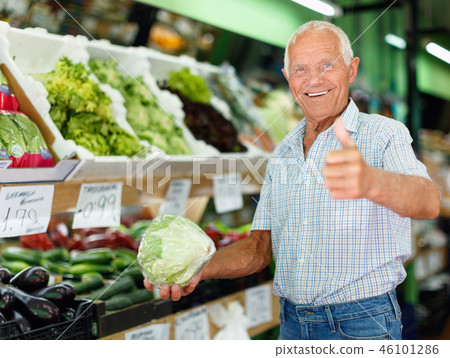 Portrait of happy elderly man giving thumbs up, satisfied with fresh products Portrait of happy elderly man giving thumbs up, satisfied with fresh products 46101286