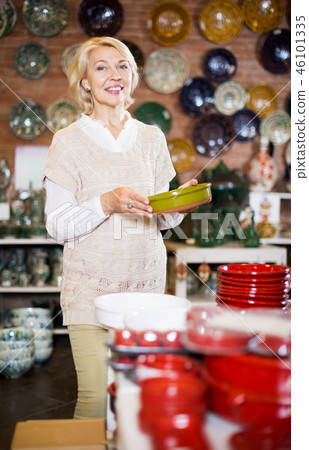 Woman posing with ceramic tableware Woman posing with ceramic tableware 46101335