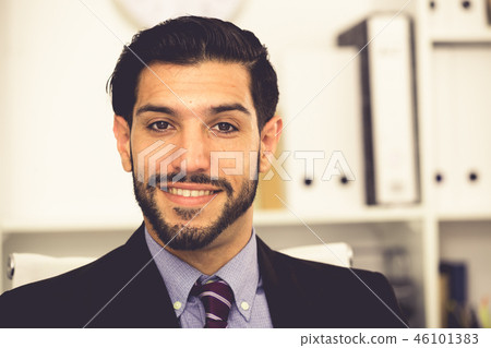Portrait of smiling businessman who is at his work place Portrait of smiling businessman who is at his work place 46101383