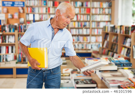 man reading new books man reading new books 46101596