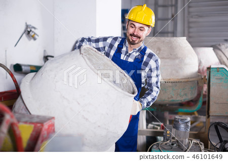 working man practicing his skills with mixing unit at workshop 46101649