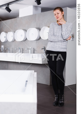 Positive girl customer buying ceramic bath in store Positive girl customer buying ceramic bath in store 46101656