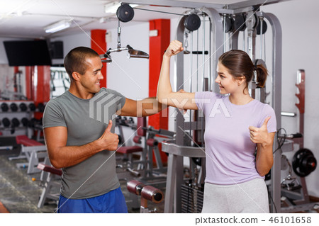 Girl and guy talking with expression at gym Girl and guy talking with expression at gym 46101658