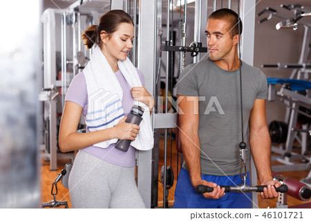 Instructor helping young woman with exercise Instructor helping young woman with exercise 46101721