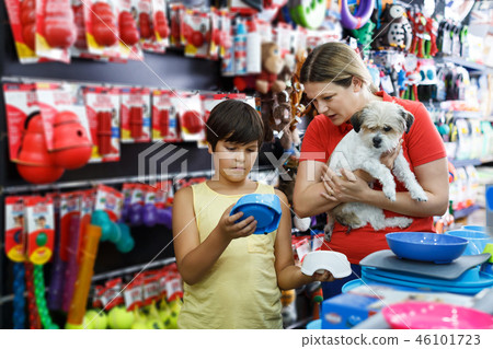 boy and his mother looking for supplies for little dog boy and his mother looking for supplies for little dog 46101723