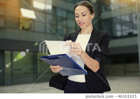 Woman is examining documents 46101815