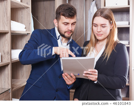Administrator and seller discussing documents Administrator and seller discussing documents 46101843
