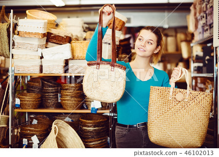 female standing with wicker bag 46102013