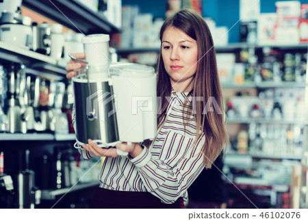 Young woman housewife looking kitchen machine Young woman housewife looking kitchen machine 46102076