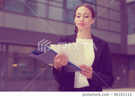 Businesswoman is examining documents Businesswoman is examining documents 46102112
