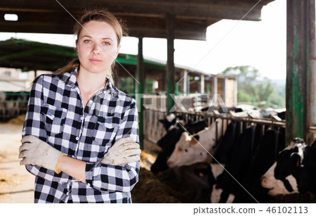 Female farmer on dairy farm Female farmer on dairy farm 46102113