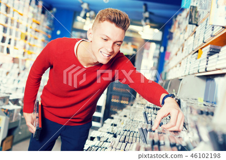 Man choosing movies on DVD Man choosing movies on DVD 46102198