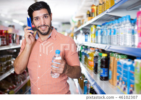 Male is talking on mobile in market 46102307