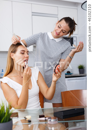 Grls having conversation and applying cosmetics Grls having conversation and applying cosmetics 46102310